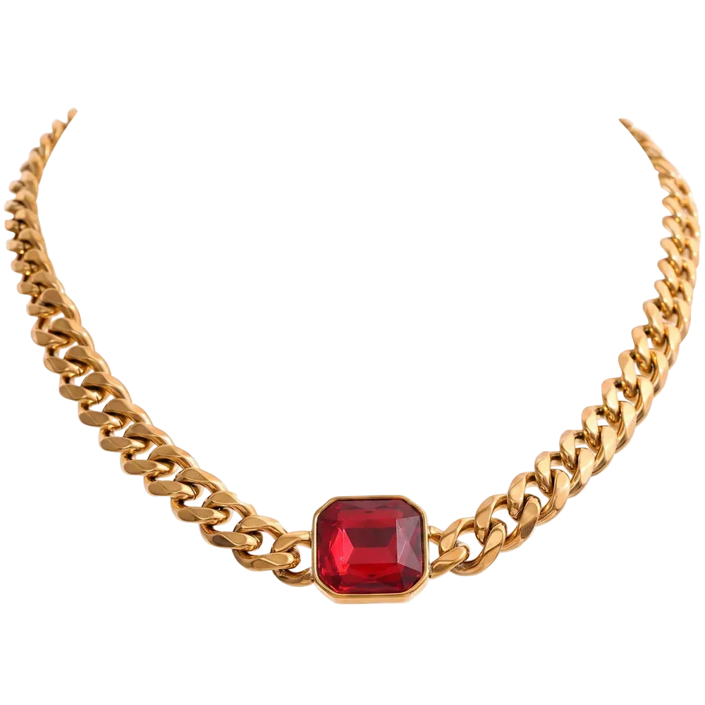 A gold-toned curb chain necklace featuring a central rectangular red gemstone pendant, shown against a plain white background.