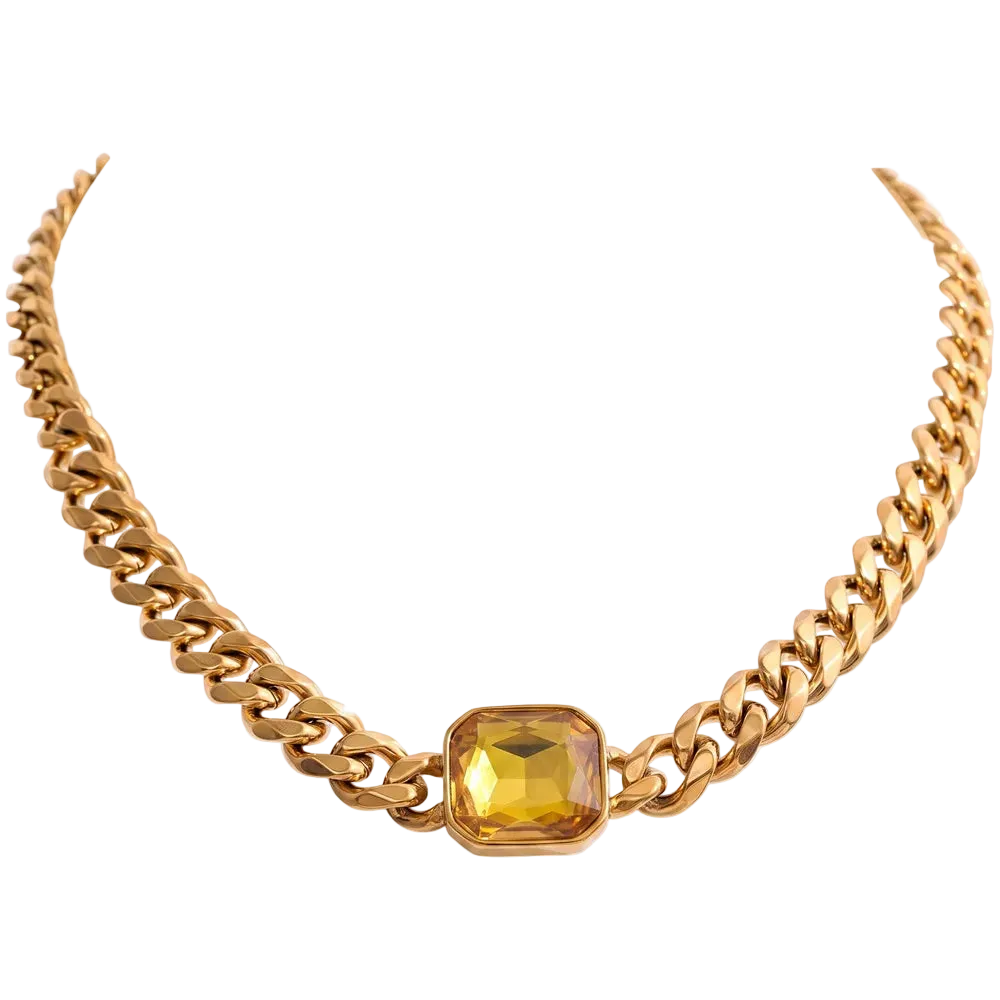 A gold-toned chunky chain necklace featuring a central faceted yellow gemstone in a gold bezel setting, presented on a solid white background.