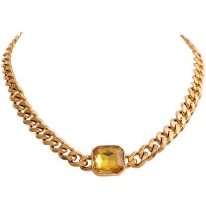 A gold-toned chunky chain necklace featuring a central faceted yellow gemstone in a gold bezel setting, presented on a solid white background.