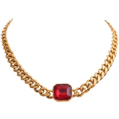 A gold-toned curb chain necklace featuring a central rectangular red gemstone pendant, shown against a plain white background.