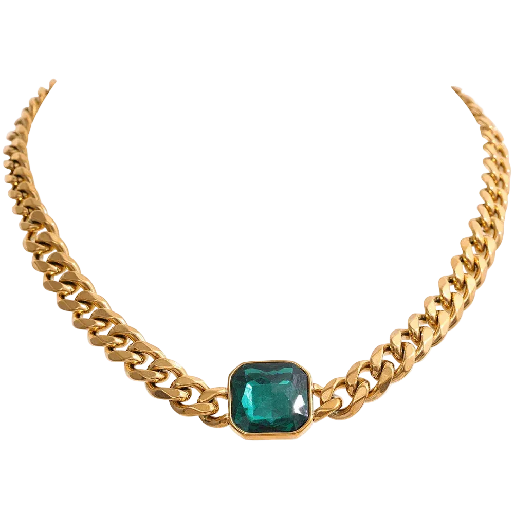 Gold chain necklace with a green gemstone on a white background